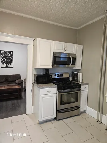 a kitchen with cabinets stainless steel appliances and a sink