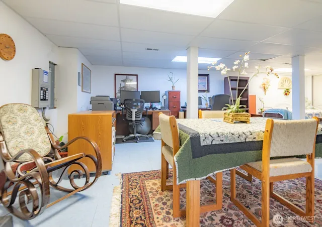 a living room with furniture a dining table and chairs with wooden floor