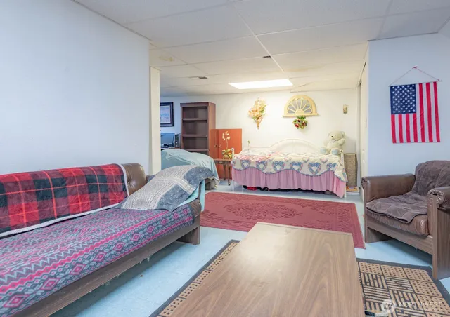 a living room with furniture fireplace and rug