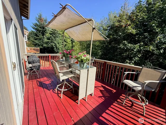 a view of balcony with furniture and umbrella