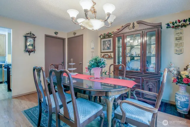 a view of a dining room with furniture and chandelier