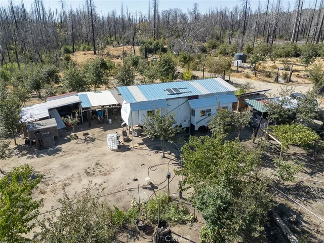 a view of a backyard with plants and a patio