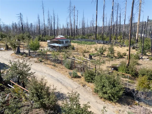 a wooden bench sitting in the middle of a yard