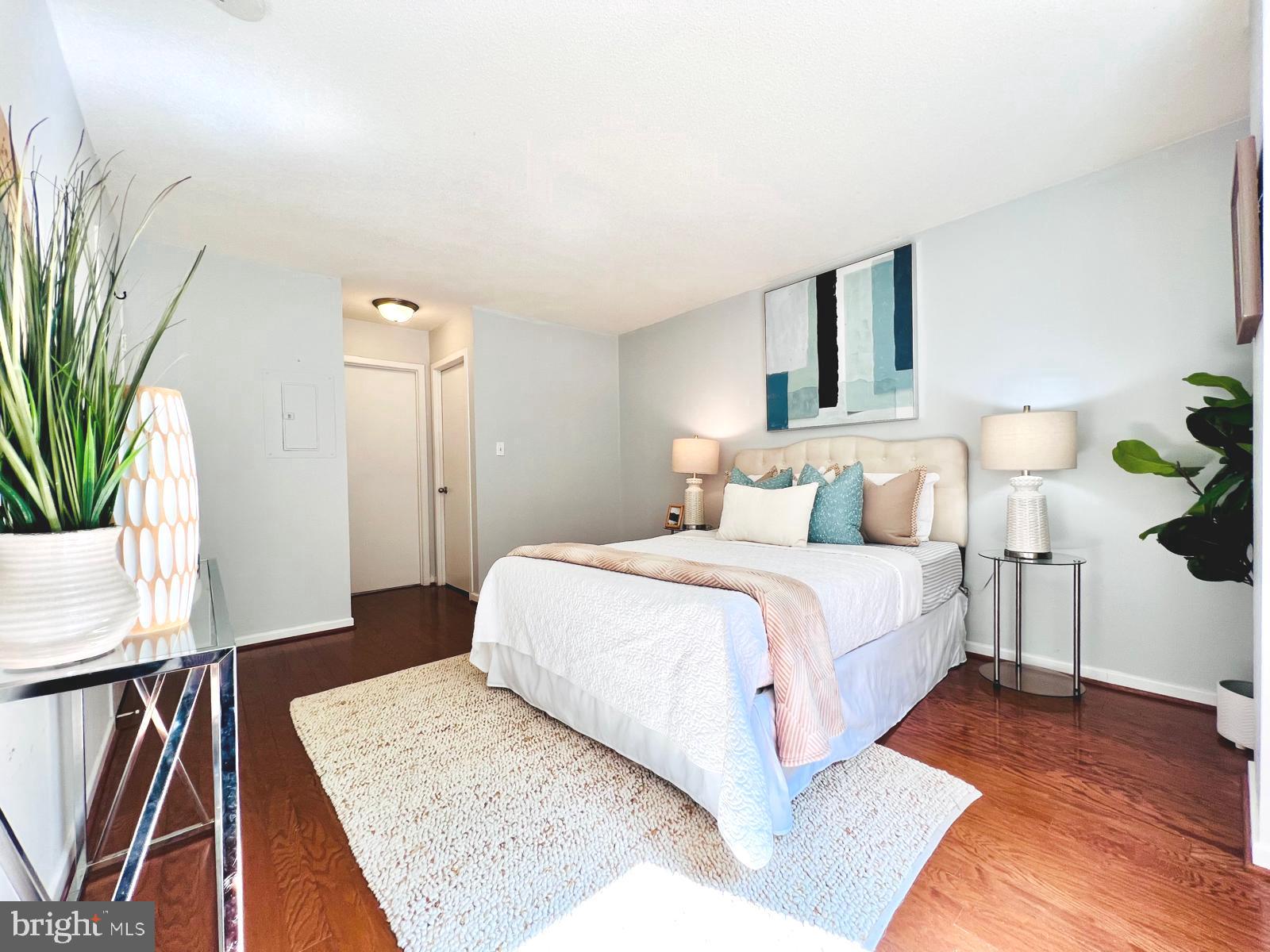 2111 Wisconsin Avenue Northwest, Unit 110 Washington, DC 20007 - Photo 11 of 32 a bedroom with a bed and wooden floor