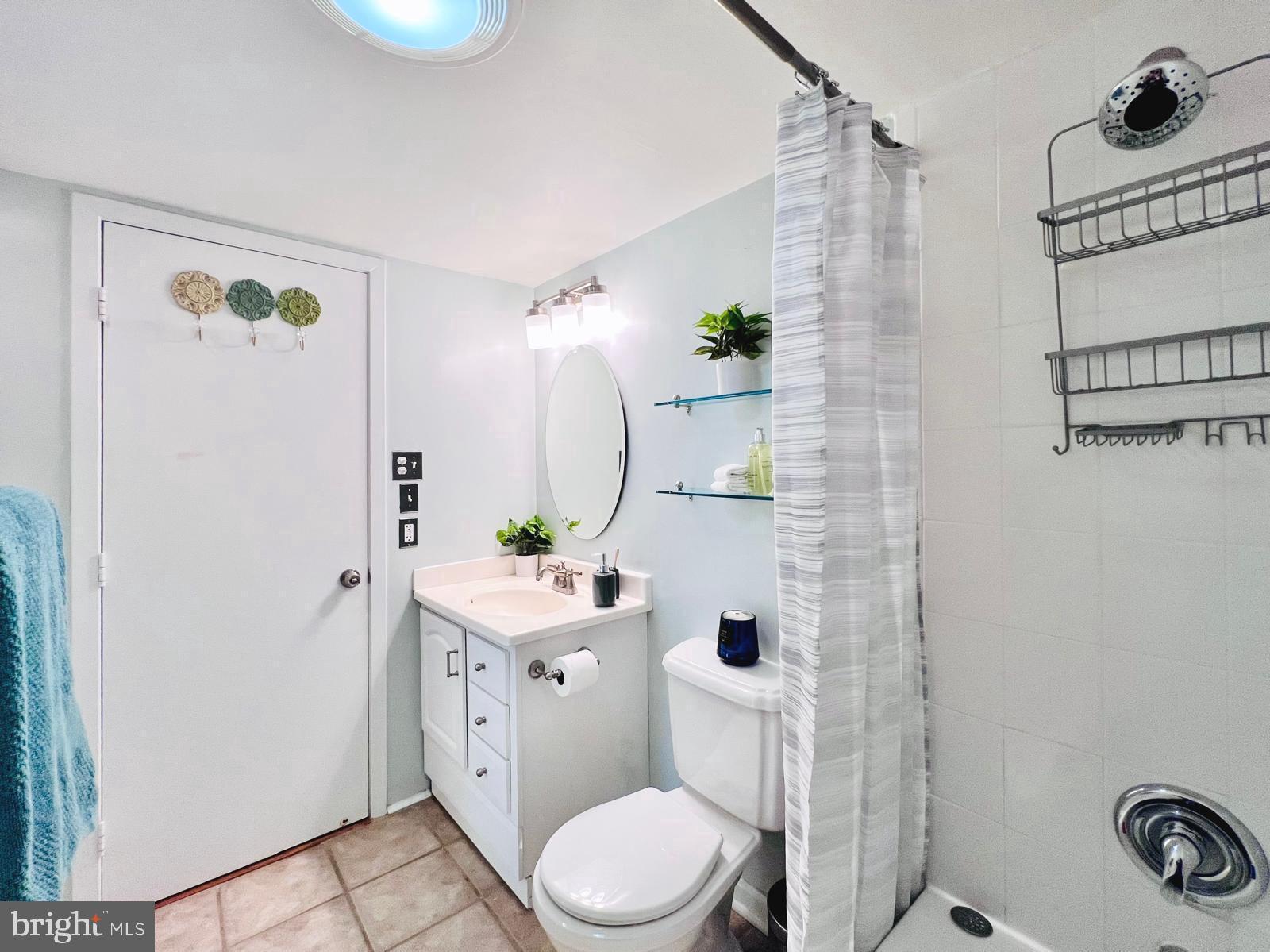 2111 Wisconsin Avenue Northwest, Unit 110 Washington, DC 20007 - Photo 15 of 32 a bathroom with a toilet a sink and a mirror