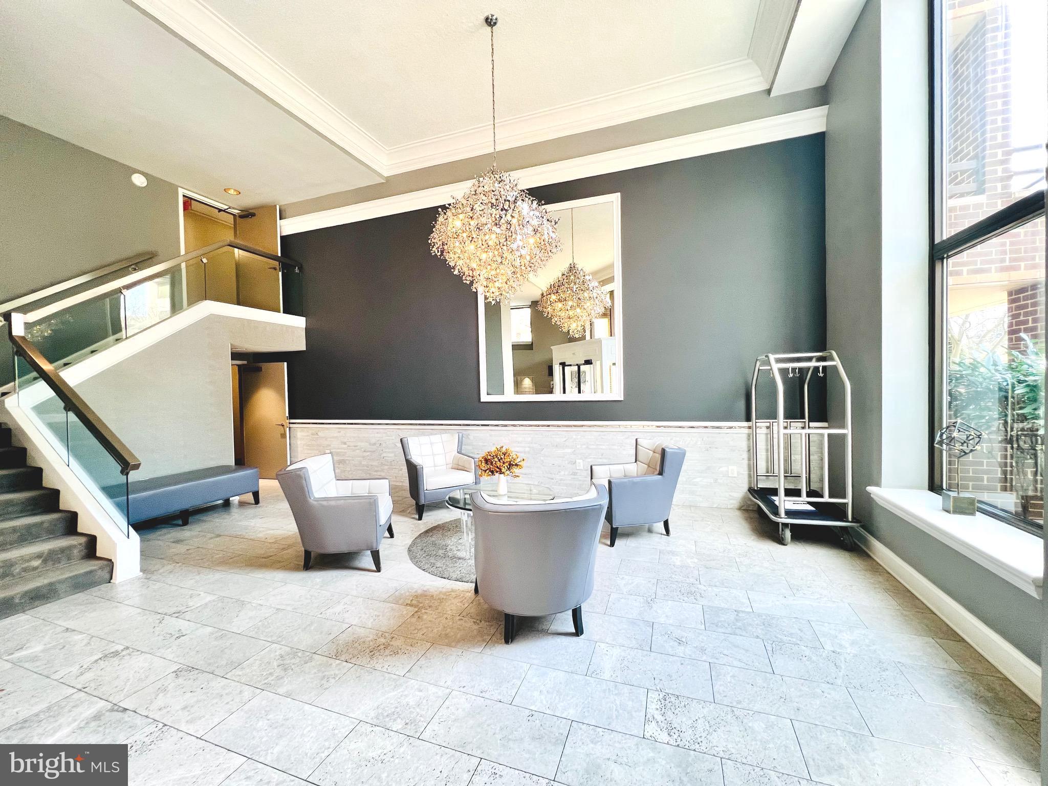 2111 Wisconsin Avenue Northwest, Unit 110 Washington, DC 20007 - Photo 27 of 32 a living room with patio furniture and a chandelier