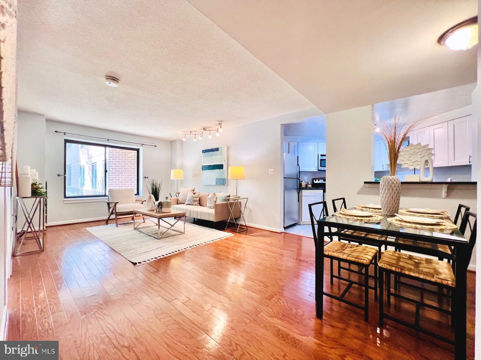 2111 Wisconsin Avenue Northwest, Unit 110 Washington, DC 20007 - Photo 3 of 32 a view of a dining room with furniture and wooden floor