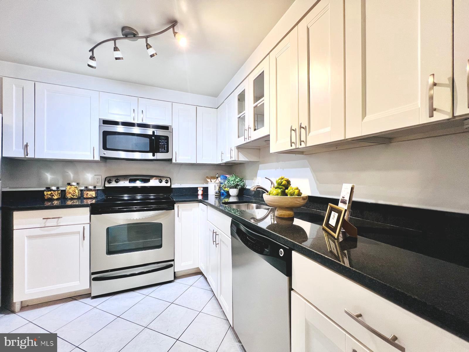 2111 Wisconsin Avenue Northwest, Unit 110 Washington, DC 20007 - Photo 6 of 32 a kitchen with cabinets a sink and appliances