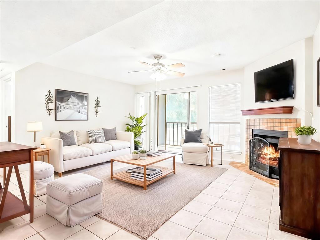 11460 Audelia Road, Unit 172 Dallas, TX 75243 - Photo 11 of 38 a living room with furniture a flat screen tv and a fireplace