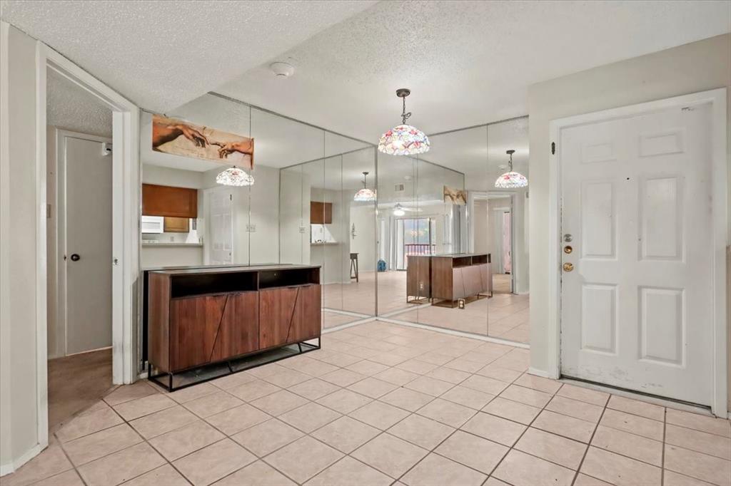 11460 Audelia Road, Unit 172 Dallas, TX 75243 - Photo 16 of 38 a living room with a large mirror and furniture