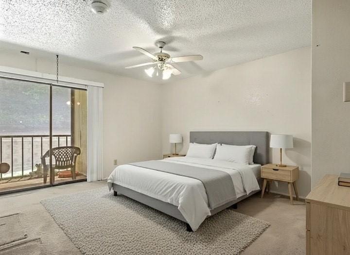 11460 Audelia Road, Unit 172 Dallas, TX 75243 - Photo 2 of 38 a bedroom with a large bed and a chandelier fan