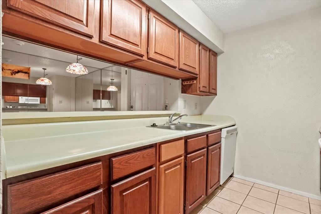 11460 Audelia Road, Unit 172 Dallas, TX 75243 - Photo 22 of 38 a kitchen with a sink cabinets and utility
