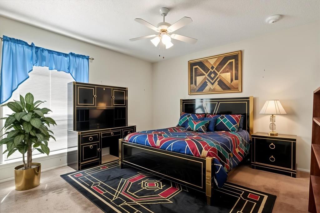 11460 Audelia Road, Unit 172 Dallas, TX 75243 - Photo 27 of 38 a bedroom with furniture and a fireplace