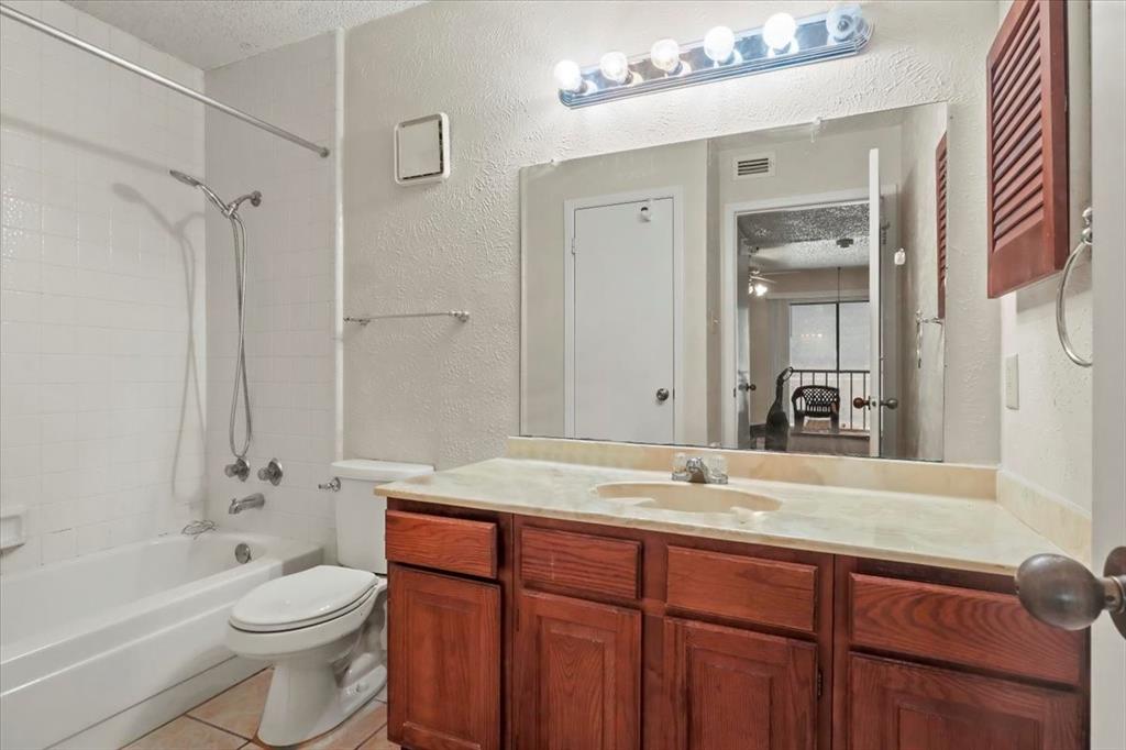11460 Audelia Road, Unit 172 Dallas, TX 75243 - Photo 28 of 38 a bathroom with a granite countertop sink toilet and shower