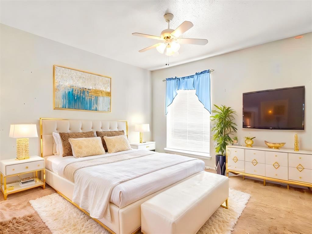 11460 Audelia Road, Unit 172 Dallas, TX 75243 - Photo 30 of 38 a spacious bedroom with a bed and a flat screen tv