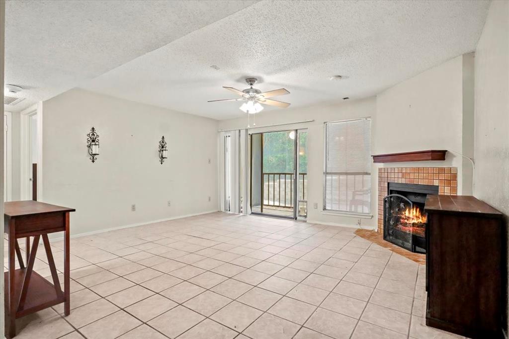 11460 Audelia Road, Unit 172 Dallas, TX 75243 - Photo 3 of 38 a view of an empty room with a fireplace