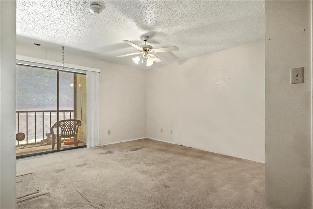 11460 Audelia Road, Unit 172 Dallas, TX 75243 - Photo 31 of 38 an empty room with chandelier fan and windows