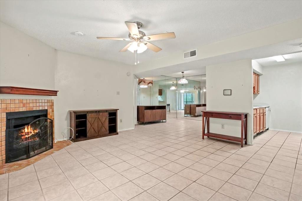 11460 Audelia Road, Unit 172 Dallas, TX 75243 - Photo 8 of 38 a bedroom with a bed and a fireplace