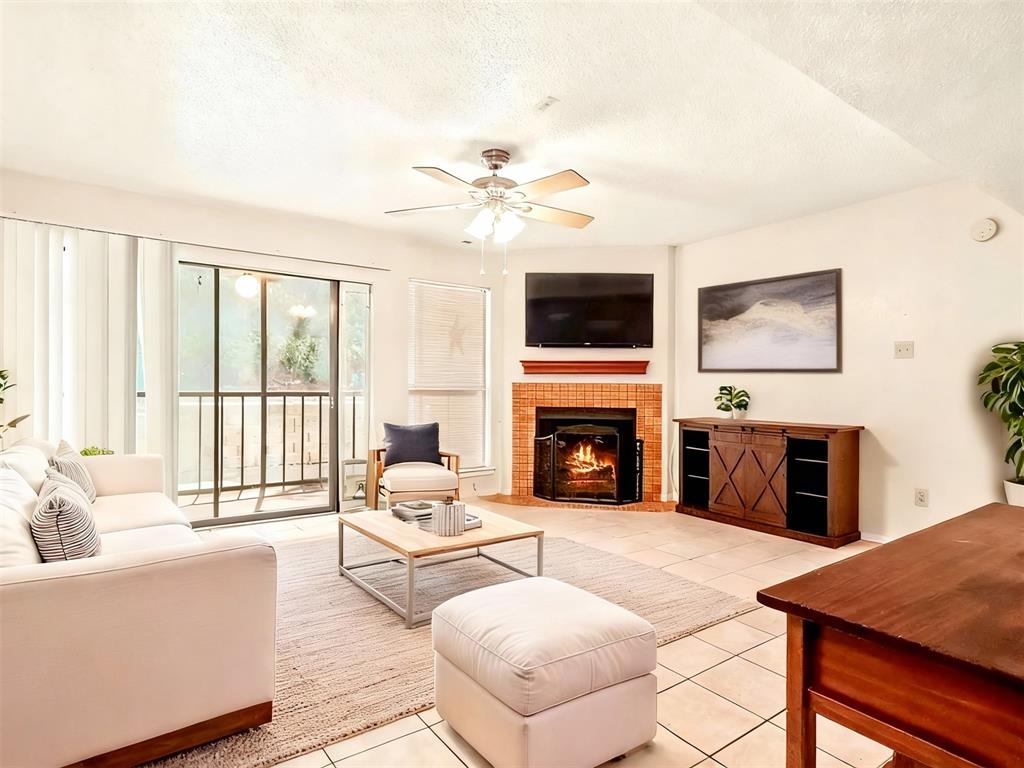 11460 Audelia Road, Unit 172 Dallas, TX 75243 - Photo 9 of 38 a living room with furniture a fireplace and a flat screen tv