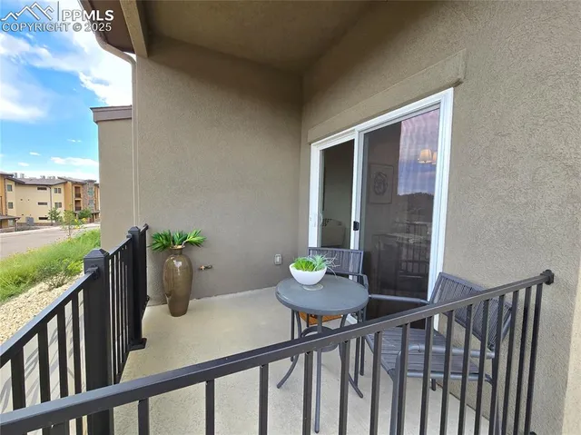 a view of a balcony with chair and wooden floor