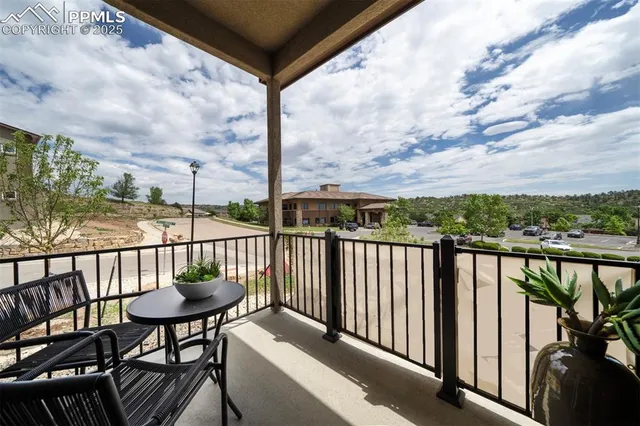 a view of a balcony with chairs and a table