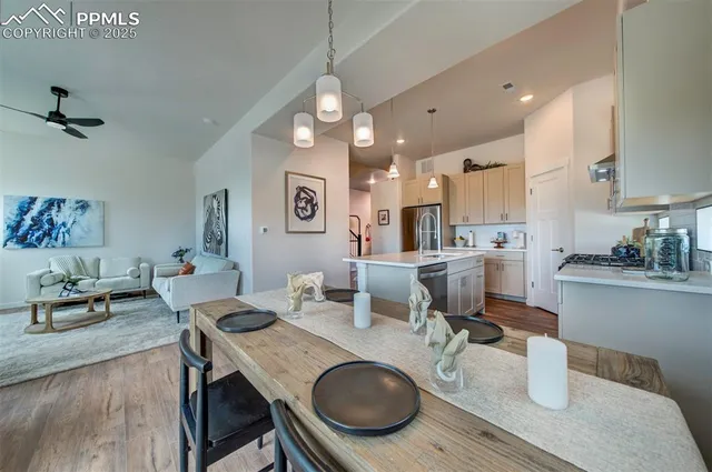 a kitchen and a dining room with wooden floor