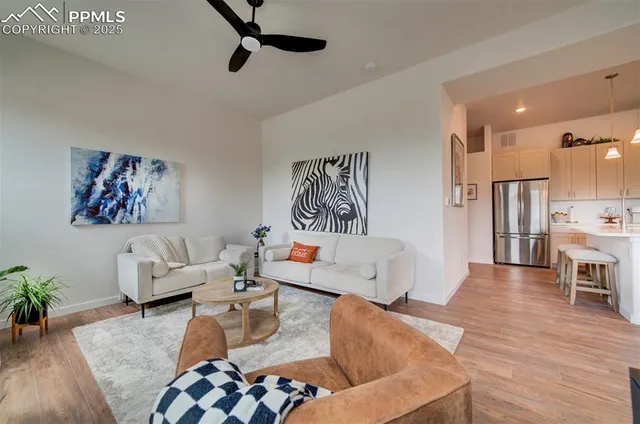 a living room with furniture or couch and a wooden floor