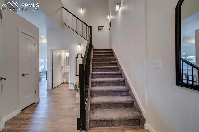 a view of entryway and hall with wooden floor