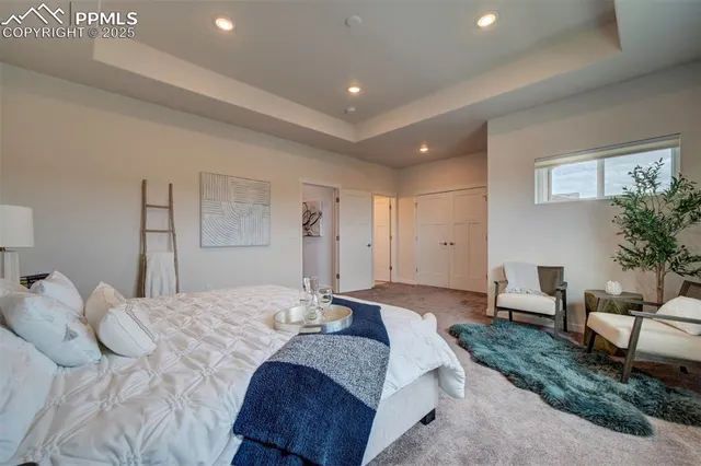 a spacious bedroom with a bed and a couch