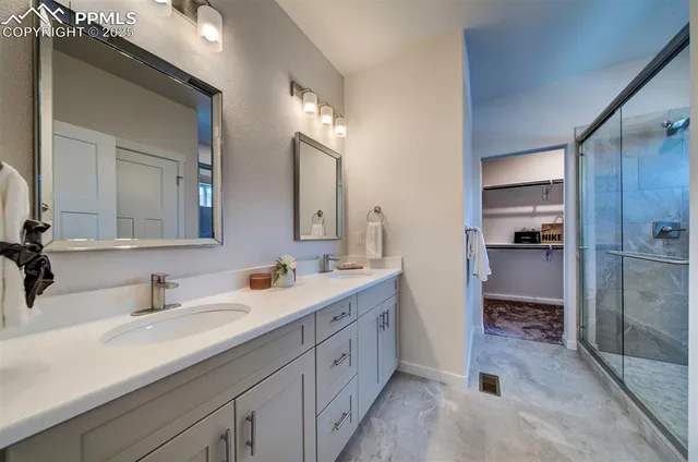 a bathroom with a double vanity sink and mirror