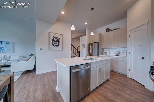 a kitchen with a sink cabinets and wooden floor