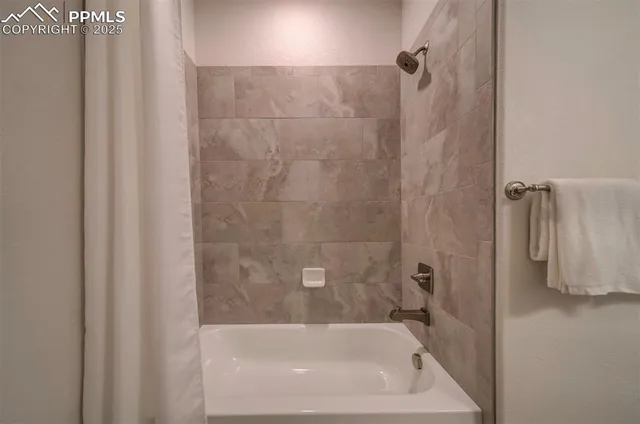 a bath tub sitting next to a shower