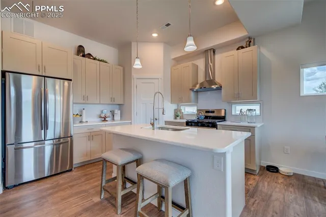a kitchen with kitchen island white cabinets and stainless steel appliances