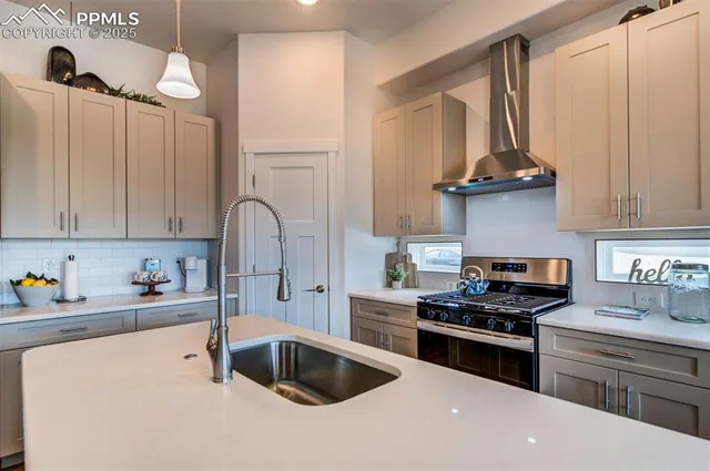 a kitchen with granite countertop a sink stainless steel appliances and cabinets