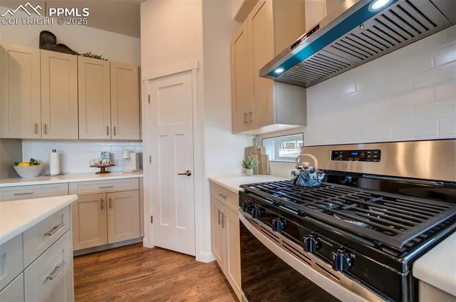 a kitchen with stove and cabinets