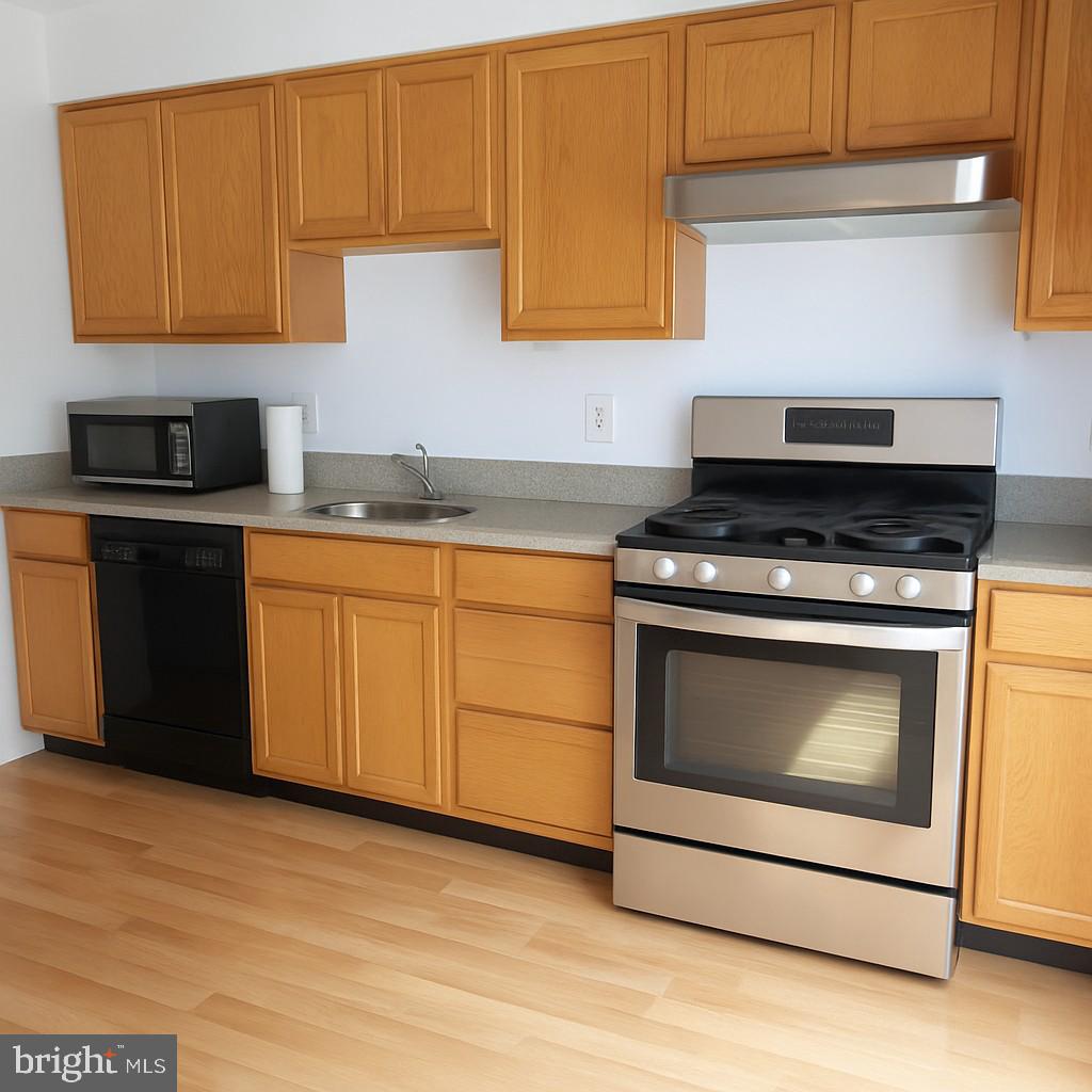 4705 Grenwich Lane Mount Laurel, NJ 08054 - Photo 2 of 12 a kitchen with granite countertop wooden cabinets stainless steel appliances and a sink