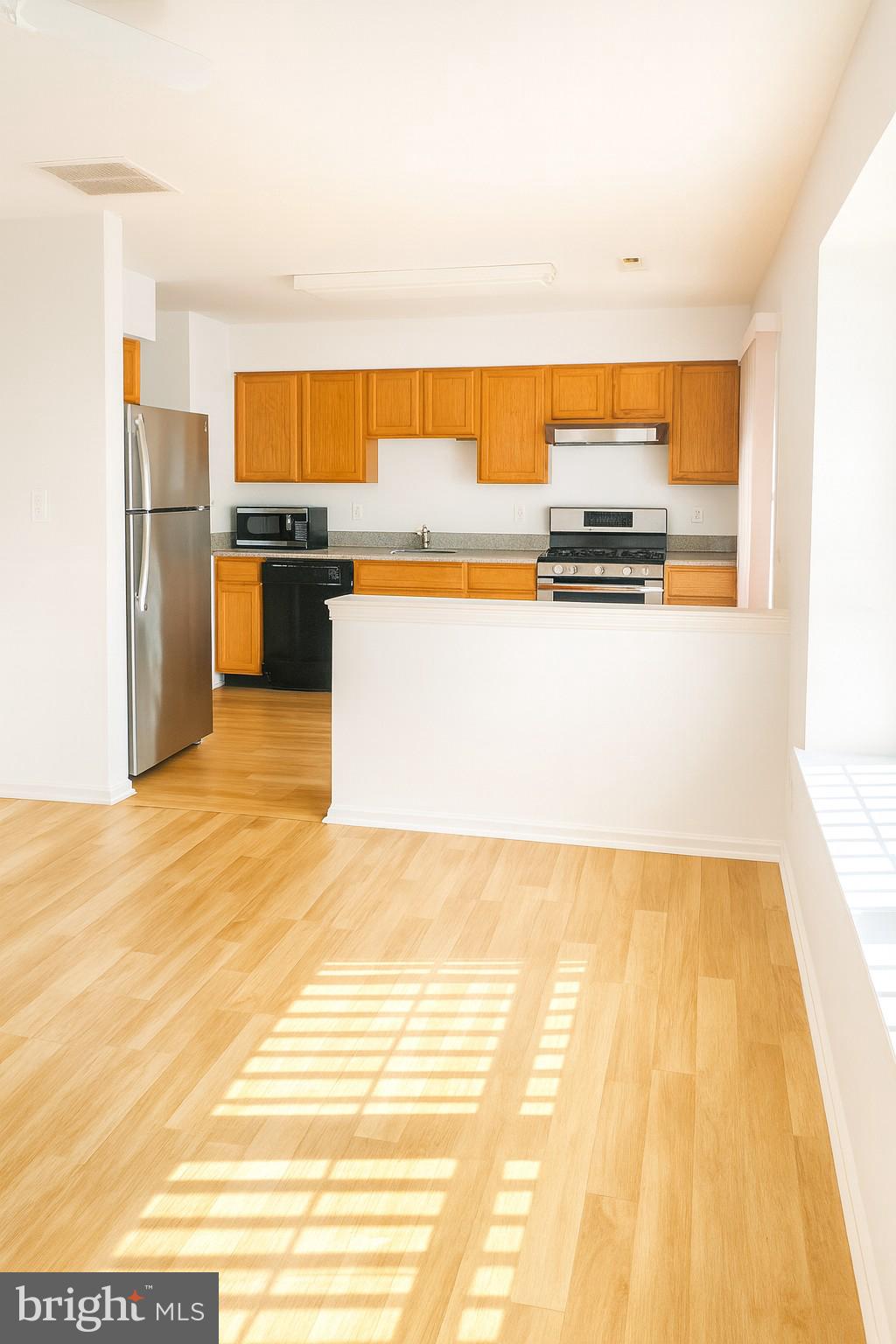 4705 Grenwich Lane Mount Laurel, NJ 08054 - Photo 4 of 12 a view of kitchen with stainless steel appliances wooden floor and chair