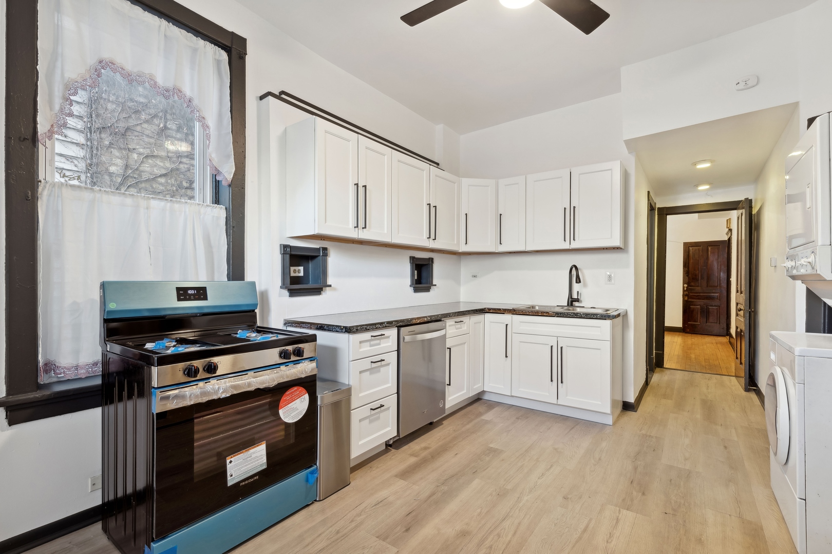 949 North Damen Avenue Chicago, IL 60622 - Photo 13 of 28 a kitchen with granite countertop a stove top oven sink and cabinets