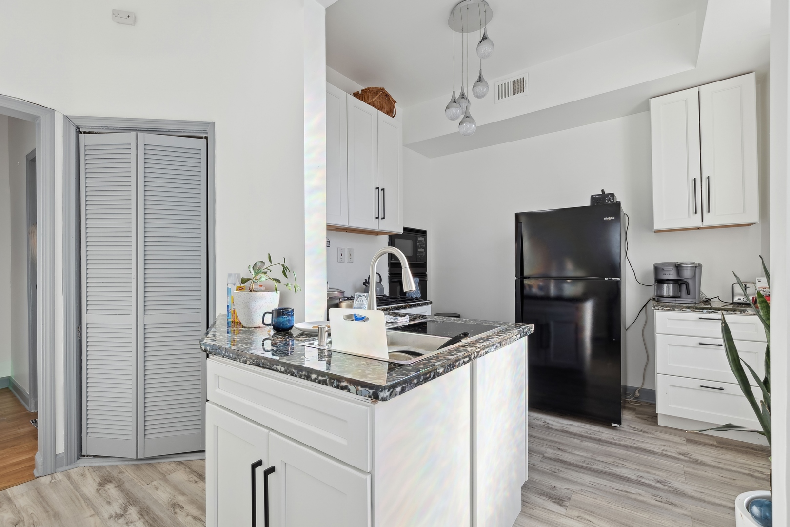 949 North Damen Avenue Chicago, IL 60622 - Photo 23 of 28 a kitchen with kitchen island a counter top space appliances and cabinets