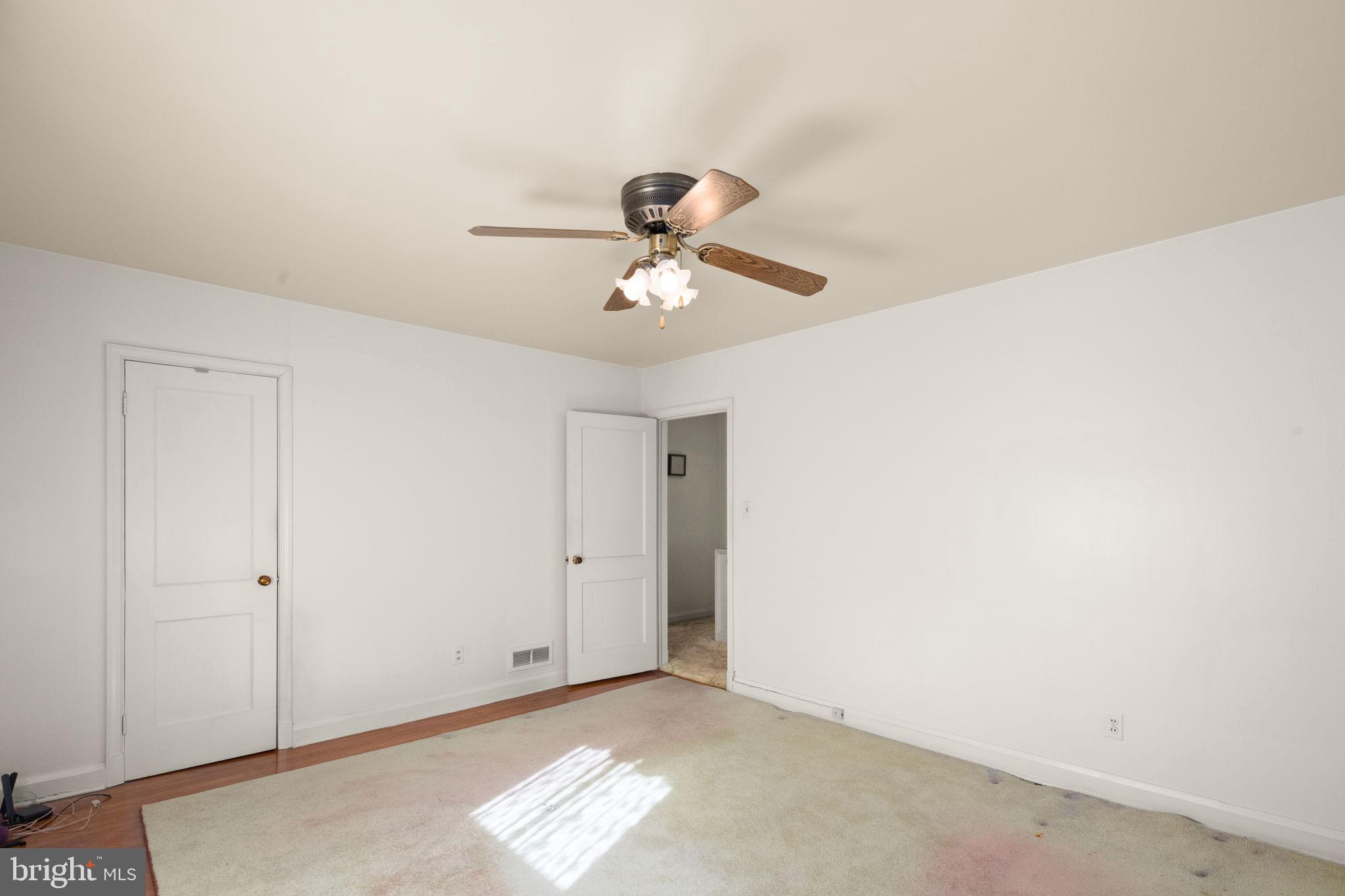 6822 Everall Avenue Baltimore, MD 21206 - Photo 12 of 21 a view of a room with a ceiling fan and carpet