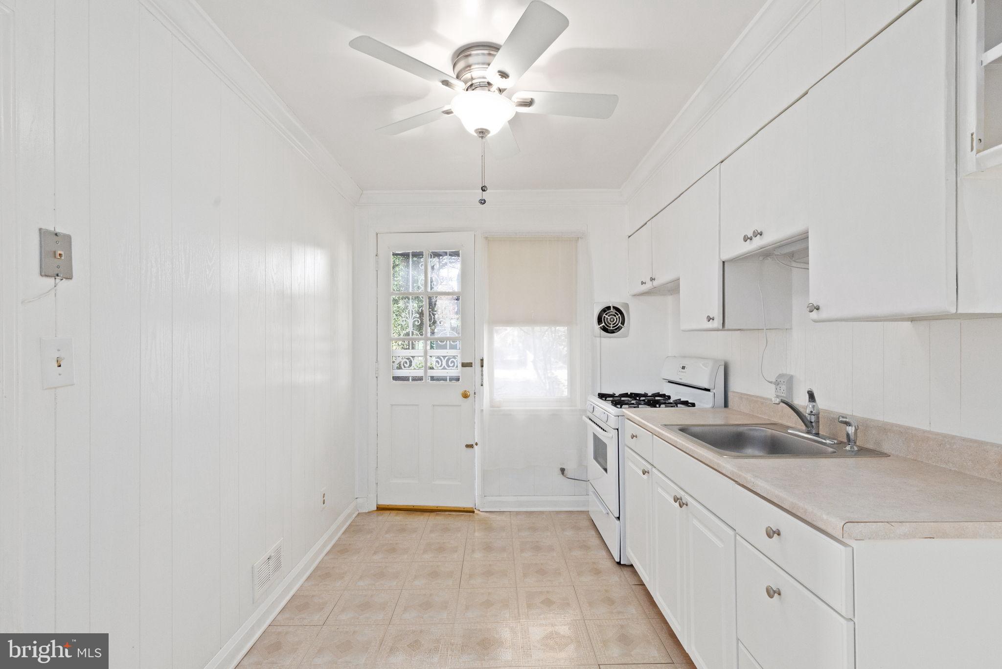 6822 Everall Avenue Baltimore, MD 21206 - Photo 8 of 21 a spacious bathroom with a granite countertop sink a mirror and a