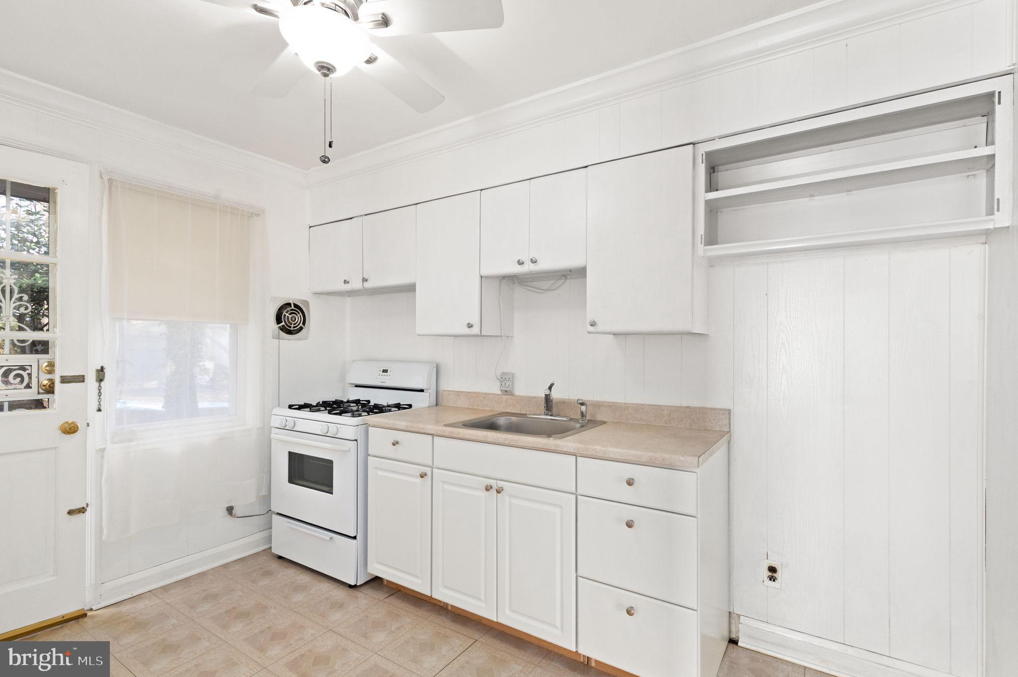 6822 Everall Avenue Baltimore, MD 21206 - Photo 10 of 21 a kitchen with white cabinets and white appliances