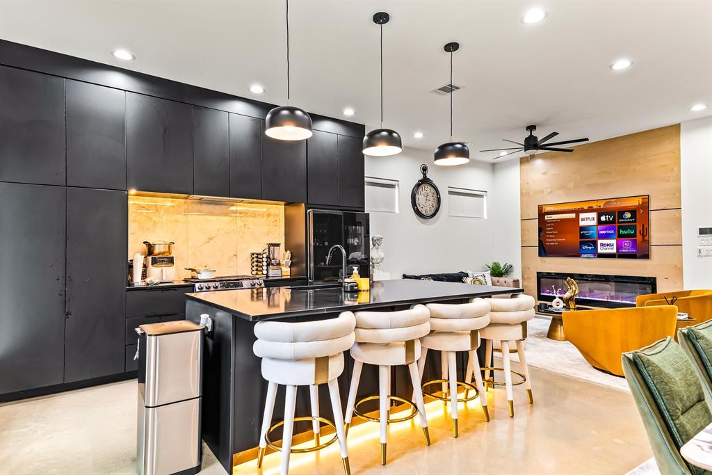1211 Bonnie View Road Dallas, TX 75203 - Photo 8 of 33 a kitchen with a table chairs and flat screen