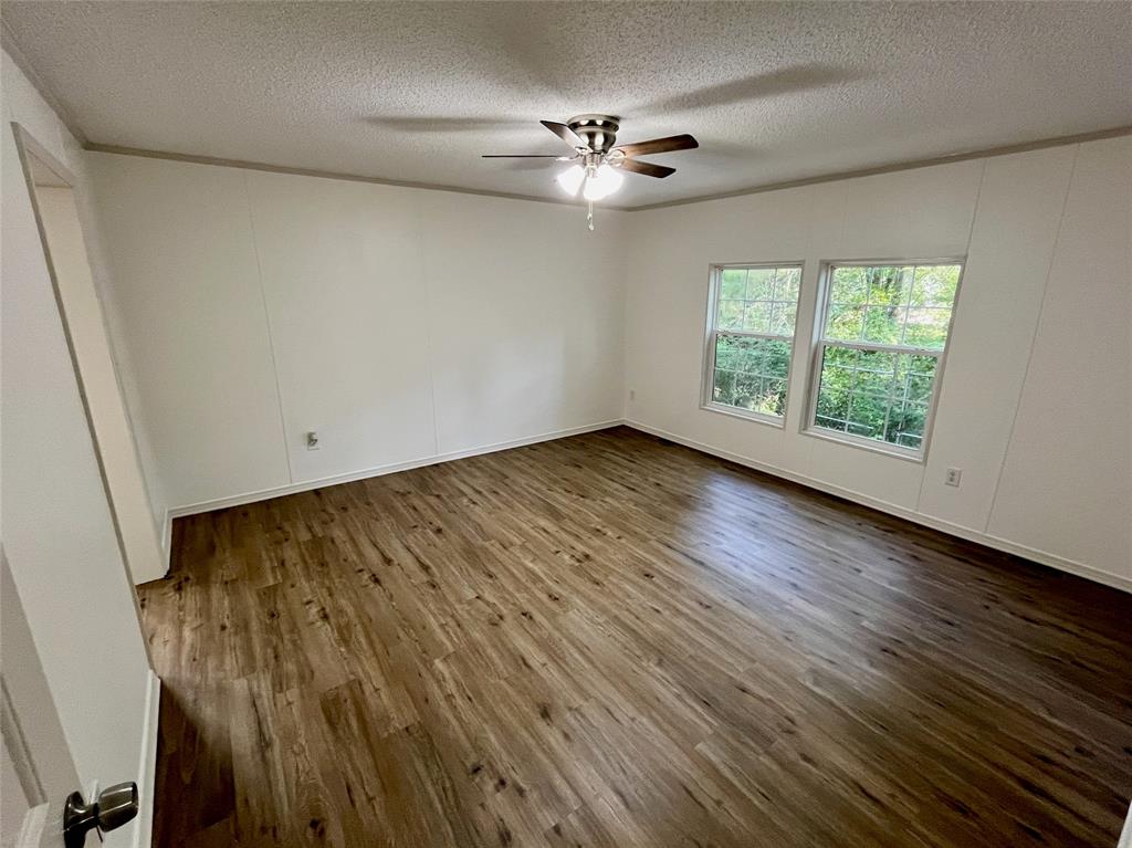 6913 Rice Road Shreveport, LA 71129 - Photo 13 of 26 a view of an empty room with wooden floor and a window