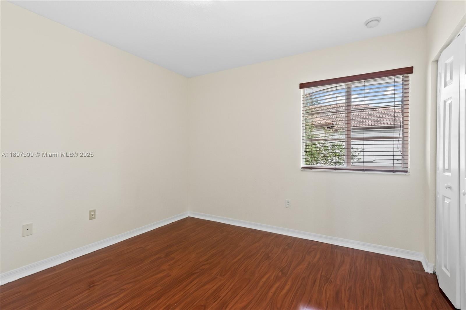 12421 Southwest 50th Court, Unit 347 Miramar, FL 33027 - Photo 12 of 25 an empty room with wooden floor and windows