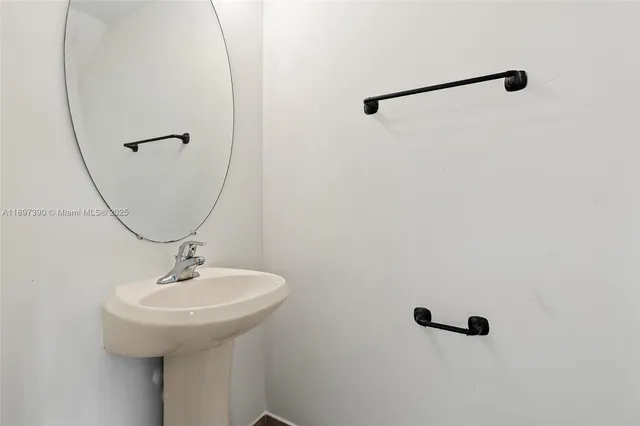 a bathroom with a sink and mirror