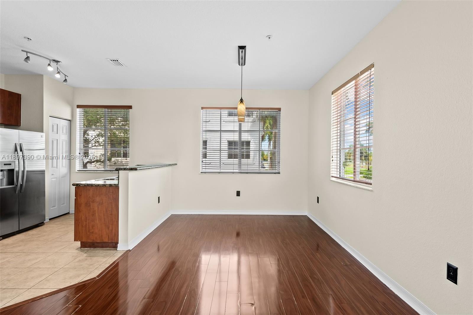 12421 Southwest 50th Court, Unit 347 Miramar, FL 33027 - Photo 15 of 25 a view of empty room with wooden floor and fan