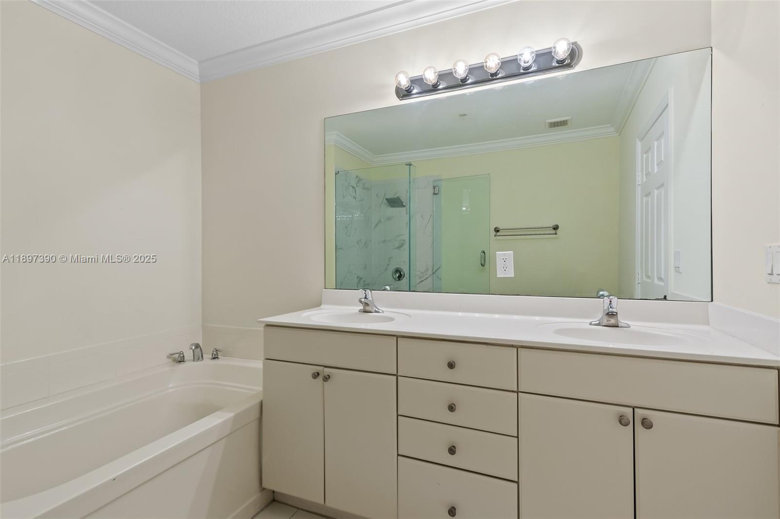 12421 Southwest 50th Court, Unit 347 Miramar, FL 33027 - Photo 5 of 25 a bathroom with a double vanity sink mirror double and bathtub