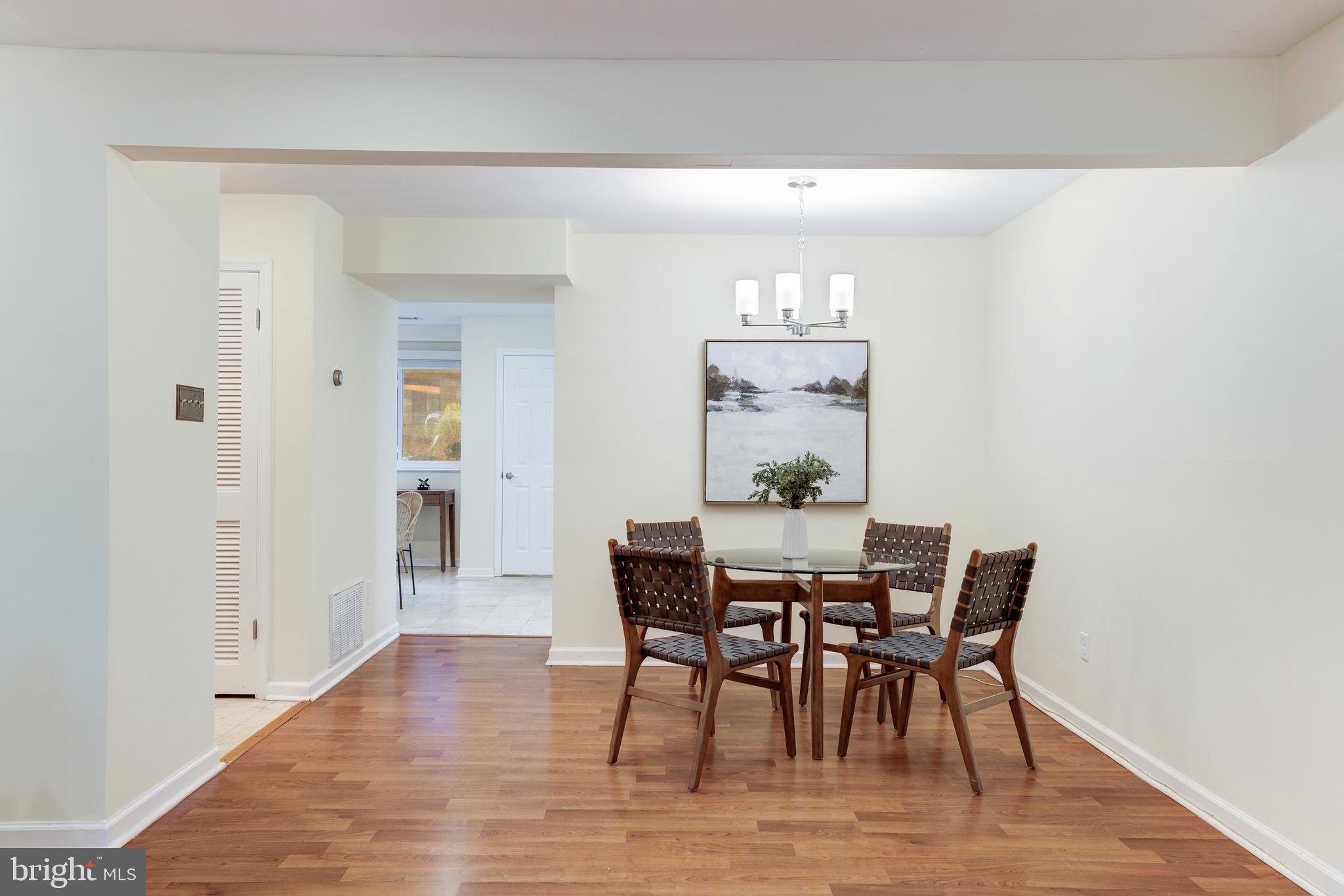 11102 Saffold Way Reston, VA 20190 - Photo 11 of 27 a view of a dining room with furniture and wooden floor