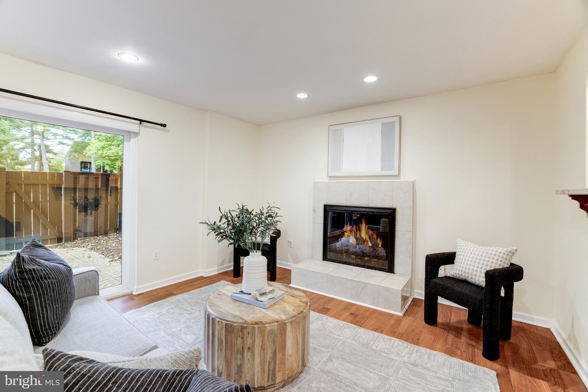 11102 Saffold Way Reston, VA 20190 - Photo 13 of 27 a living room with furniture and a fireplace